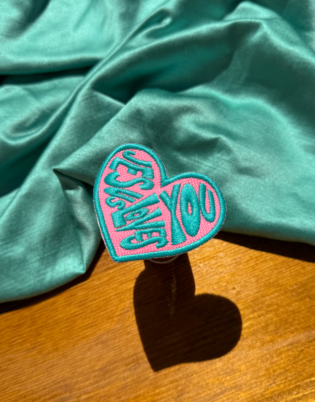 teal and pink trucker hat patch jesus loves you black and white patch